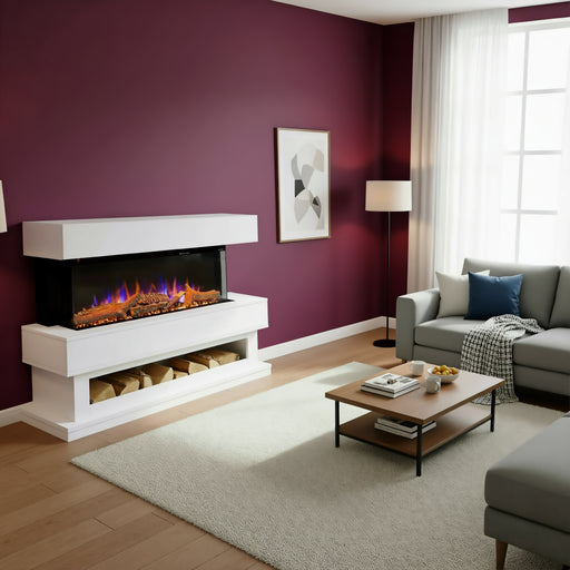 A modern white electric fireplace with a floating mantel and log storage, set against a deep burgundy wall in a styled living room with a gray sofa, wooden coffee table, and a light beige rug.
