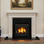 Living room with a fireplace, blue sofa, and painting on the wall.