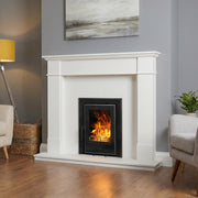 Living room with a white fireplace, beige sofa, gray armchair, and yellow lamp.