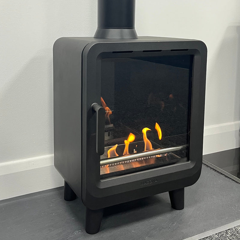 Modern black fireplace insert with visible flames on a white surface.