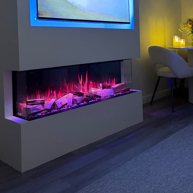 Modern living room with a fireplace and wall-mounted TV displaying a scenic image.
