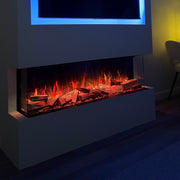 Modern electric fireplace with glowing logs and a television above it in a dimly lit room.