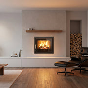 Modern living room with a fireplace, chairs, and decorative elements.