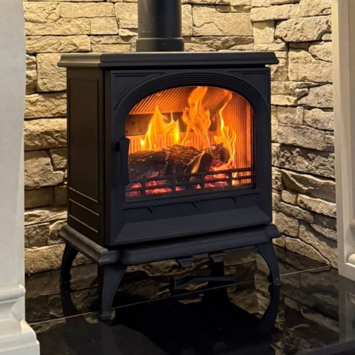 Black Multifuel Woodburning Stove against brick wall 