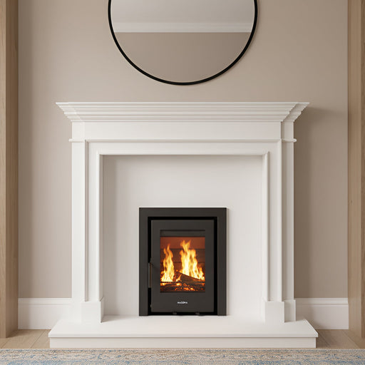 White fireplace with a fire burning between two wooden bookshelves filled with books and decorative items.