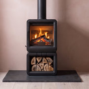 minimalist room with logstore stove burning on granite hearth 