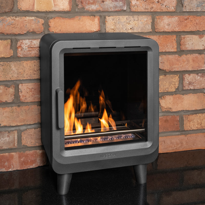 Mazona heatwave stove with flame and red brick wall 