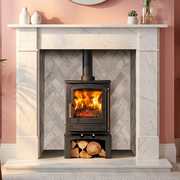 Mazona stove with log store in marble fireplace with brick cladding and modern room decor 