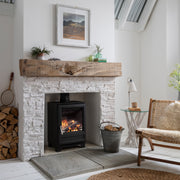Arada Ecoburn Plus 5 kW with white fireplace in a living room