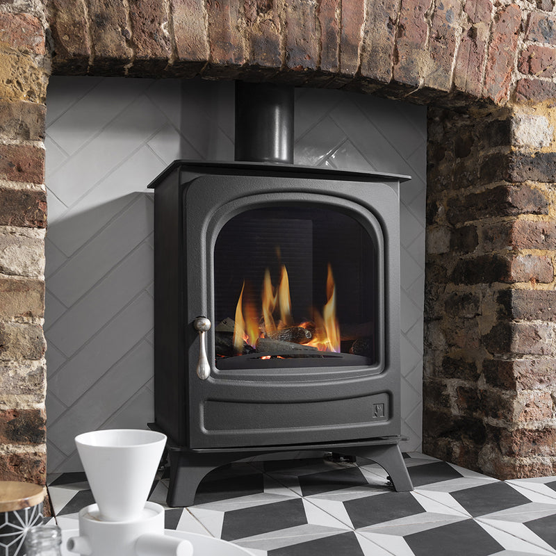 Arada Holborn 4.5 NG Black Gas Stove in a brick fireplace