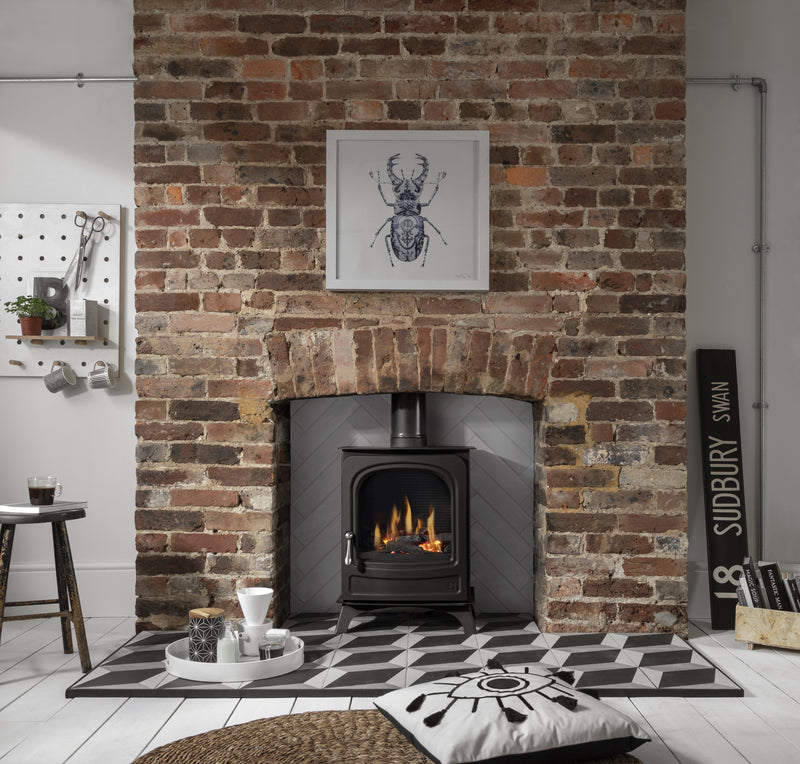 Arada Holborn 4.5 LPG Black Gas Stove in a brick fireplace in a living room
